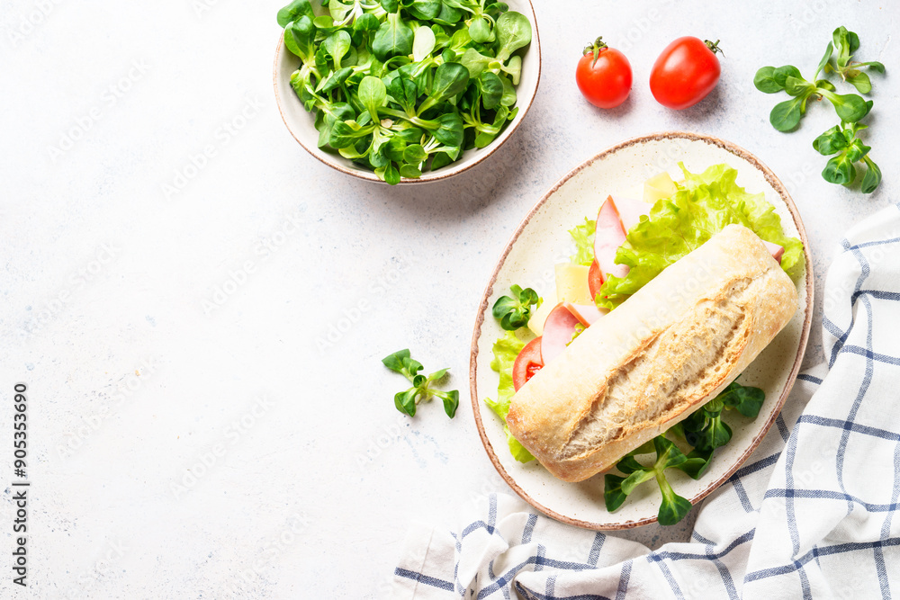 Sticker Ciabatta sandwich with lettuce, cheese, tomatoes and ham. Fast food, snack or lunch. Top view on white with copy space.