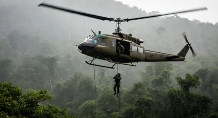 A military helicopter hovering above a dense Vietnamese jungle in heavy rain, with soldiers rappelling down into the thick greenery below.
