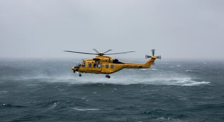 Fototapeta premium A rescue helicopter hovering above a turbulent ocean, battling heavy rain and powerful gusts as it searches for a stranded vessel. 