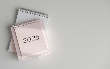 Top view of calendar 2025 on white background