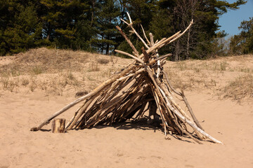A driftwood tipi on the beach at Kohler-Andrae State Park, Sheboygan, Wisconsin on a sunny mid-May...