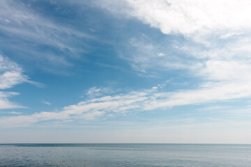 Obraz premium The calm waters of Lake Michigan beneath the wispy clouds, just off Point Beach State Park, Two Rivers, Wisconsin in early June