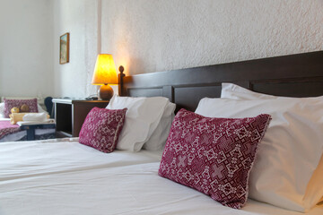 Retro bedroom style with red pattern pillows on bed