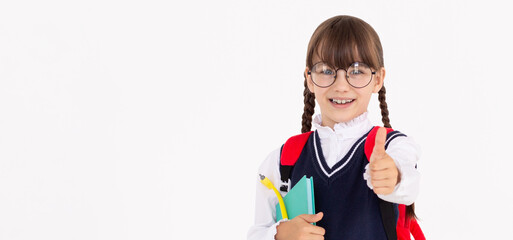 Cheerful School Girl Gesturing Thumbs-Up Smiling To Camera Posing Over white Studio Background. I Like School Concept. Panorama