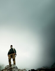 Sky space, rock or man hiking in outdoor adventure or journey in nature for travel or walking. Low angle, view mockup and hiker on mountain peak for holiday vacation, exercise or trekking to explore