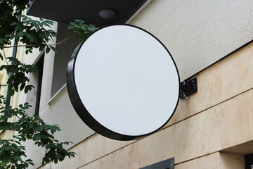Rounded Street storefront shop, cafe, restaurant mounted signboard mock up design template. Blank...