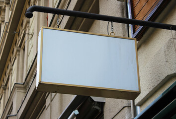 Street storefront shop, cafe, restaurant mounted signboard mock up design template. Blank white store sign design mockup.