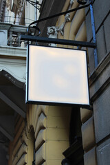 Street storefront shop, cafe, restaurant mounted signboard mock up design template. Blank white store sign design mockup.