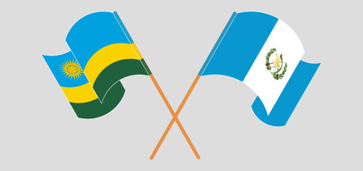 Crossed and waving flags of Rwanda and Republic of Guatemala