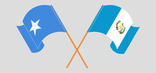 Crossed and waving flags of Somalia and Republic of Guatemala