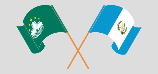 Crossed and waving flags of Macau and Republic of Guatemala