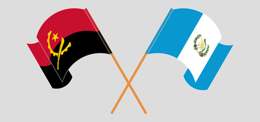 Crossed and waving flags of Angola and Republic of Guatemala