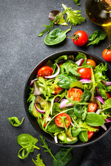 Healthy food, vegan bowl. Green Salad with fresh leaves and vegetables. Flat lay with copy space.