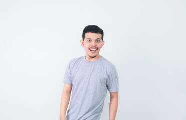 Obraz premium Asian young man grey shirt feels amazed turn back to looking isolated