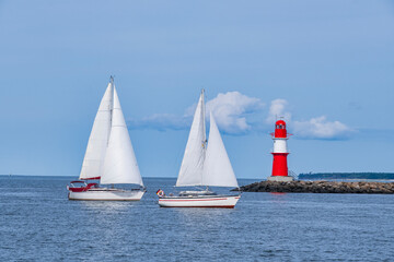 Two sailboats arrive in the port of Warnemünde