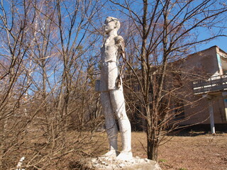 Old sculptures of children in a children's camp. Abandoned place.