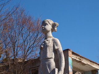 Old sculptures of children in a children's camp. Abandoned place.