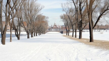 Obraz premium A winter landscape showcases a snowy park with trees and a historic building under a bright blue sky dotted with clouds