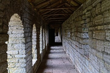 Obraz premium View of the covered defensive gallery of an ancient stone fortress. 