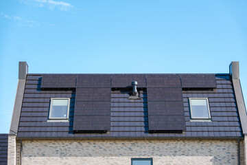 Sleek Solar Panels Harnessing Sun Energy on a Modern Roof Under Clear Blue Skies
