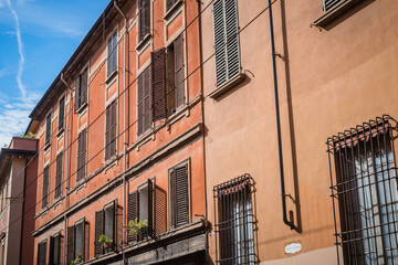 Obraz premium Facade with typical windows with wooden shutters from the city of Bologna, ITALY