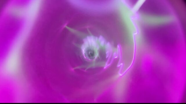Pink gas electric discharge in transparent glass tube