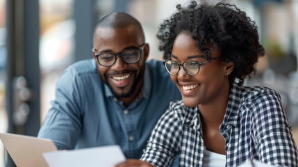 Reviewing documents together with a sense of satisfaction - Photos of happy African-Americans in business negotiations