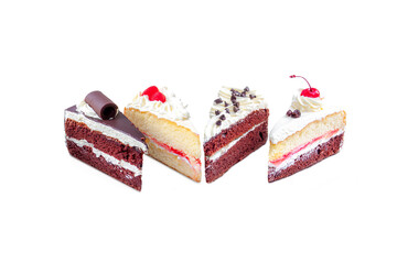 piece of chocolate layer cake with chocolate ship topping cream and vanilla layer cake with cherry currant cream on gray background