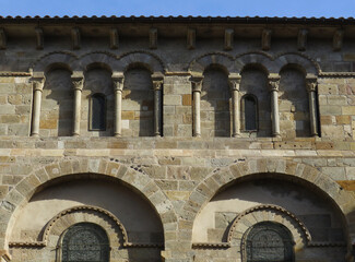 Basilica of Notre Dame du Port. 12th century. UNESCO World Heritage. Detail of the lateral south facade decorated with blid arches. Historic city of Clermont-Ferrand. France.