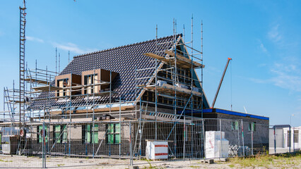 Modern Family Homes Under Construction in Dutch Suburban Area on a Sunny Day
