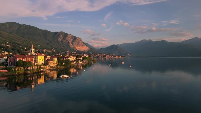 Drone captures Lago Maggiore, with Stresa and Isola Bella islands bathed in the morning sun.