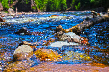 water flowing into the river over stones