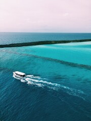 Naklejka premium Cruise ship view of Bahamas island with a boat driving