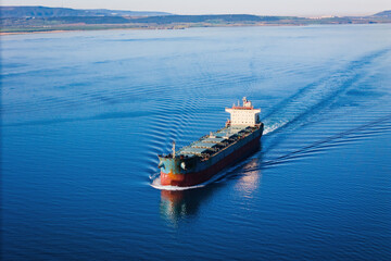 Bulk carrier or bulker underway in sea, ship for unpackaged bulk dry cargo, Aerial drone view