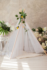 decoration wigwam with flowers in the room