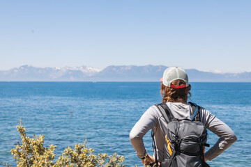 Hiker Observing Scenic View of the lake Tahoe With Mountains on the background