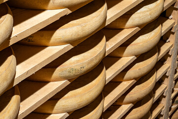 Aging rooms with shelves in cheese caves, central location for aging of wheels, rounds of Comte cheese from four months to several years made from raw cow milk, Jura, France