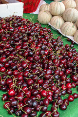 New harvest of fresh ripe dark red cherry berry on farmers market in Sisteron, Provence, France close up