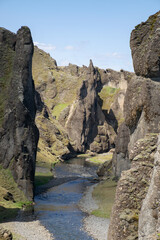 Icelandic nature, landscape background. Canyon with steep cliffs and rock formations. Summer sunny day. Exploring adventure Iceland, 