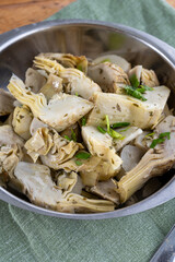 Italian food, pickled grilled artichokes hearts in olive oil close up