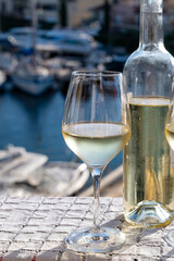 Glasses of cold white Cote de Provence wine in yacht harbour of Port Grimaud, summer vacation on French Riviera in Provence, France, wine tasting