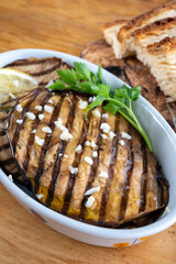 Italian style starter served in restaurant, grilled eggplant with garlic, olive oil and fresh parsley
