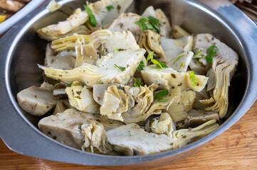 Italian food, pickled grilled artichokes hearts in olive oil close up