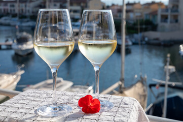Glasses of cold white Cote de Provence wine in yacht harbour of Port Grimaud, summer vacation on French Riviera in Provence, France, wine tasting