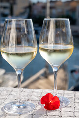 Glasses of cold white Cote de Provence wine in yacht harbour of Port Grimaud, summer vacation on French Riviera in Provence, France, wine tasting