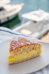 Cake of French Riviera, Tarte Tropezienne cake in yacht harbour of Port Grimaud, summer vacation in Provence, France