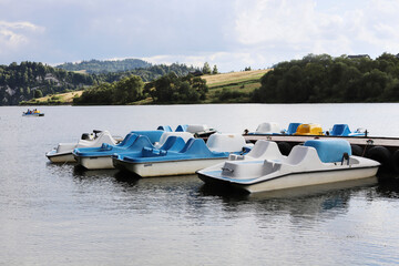 Fototapeta premium A bay where pedal boats await tourists on a sunny summer day.