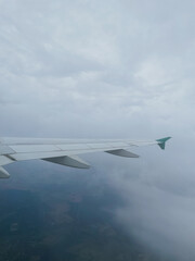  view from airplane window with sky and clouds during flight on vacation