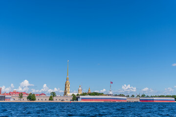 Naklejka premium Side view of Saints Peter and Paul Cathedral in Peter and Paul Fortress in a sunny summer day in Saint Petersburg, Russia. Clear blue sky. Copy space. Russian culture and architecture theme.