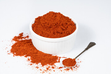 Spice ground smoked paprika on a white background.